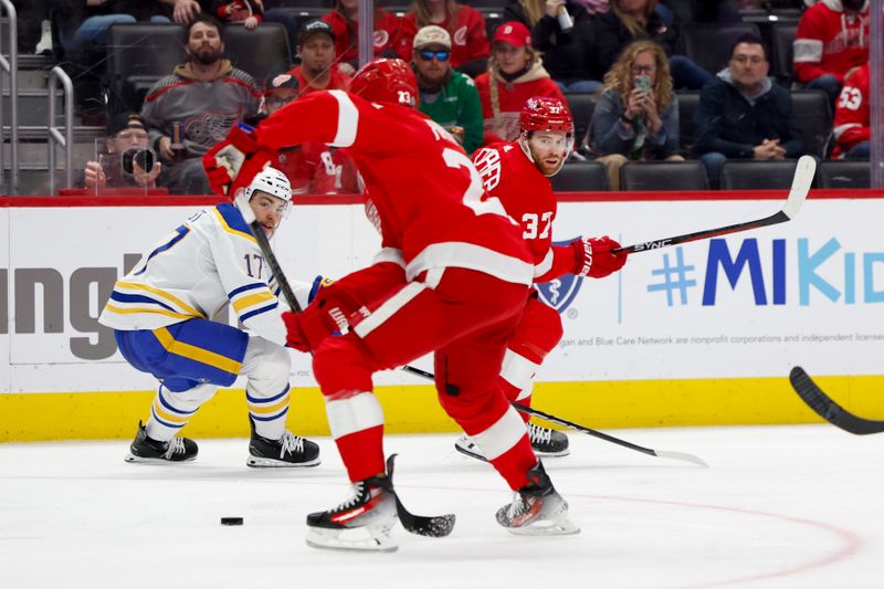 Mar 16, 2024; Detroit, Michigan, USA;  Detroit Red Wings left wing J.T. Compher (37) passes to left wing Lucas Raymond (23) in the second period against the Buffalo Sabres at Little Caesars Arena. Mandatory Credit: Rick Osentoski-USA TODAY Sports