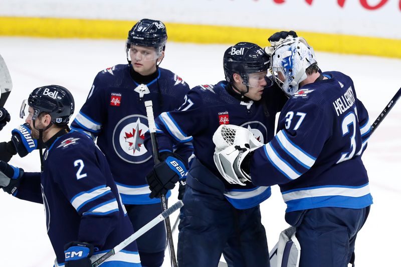 Apr 4, 2024; Winnipeg, Manitoba, CAN; Winnipeg Jets players celebrates their victory over the Calgary Flames at Canada Life Centre. Mandatory Credit: James Carey Lauder-USA TODAY Sports