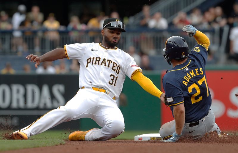 Sep 26, 2024; Pittsburgh, Pennsylvania, USA;  Milwaukee Brewers shortstop Willy Adames (27) steals second base as Pittsburgh Pirates shortstop Liover Peguero (31) takes a wide throw during the fourth inning at PNC Park. Mandatory Credit: Charles LeClaire-Imagn Images