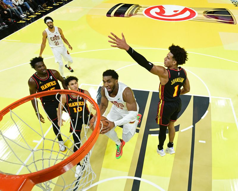 ATLANTA, GA - NOVEMBER 29: Donovan Mitchell #45 of the Cleveland Cavaliers drives to the basket during the game against the Atlanta Hawks during the Emirates NBA Cup game on November 29, 2024 at State Farm Arena in Atlanta, Georgia.  NOTE TO USER: User expressly acknowledges and agrees that, by downloading and/or using this Photograph, user is consenting to the terms and conditions of the Getty Images License Agreement. Mandatory Copyright Notice: Copyright 2024 NBAE (Photo by Adam Hagy/NBAE via Getty Images)