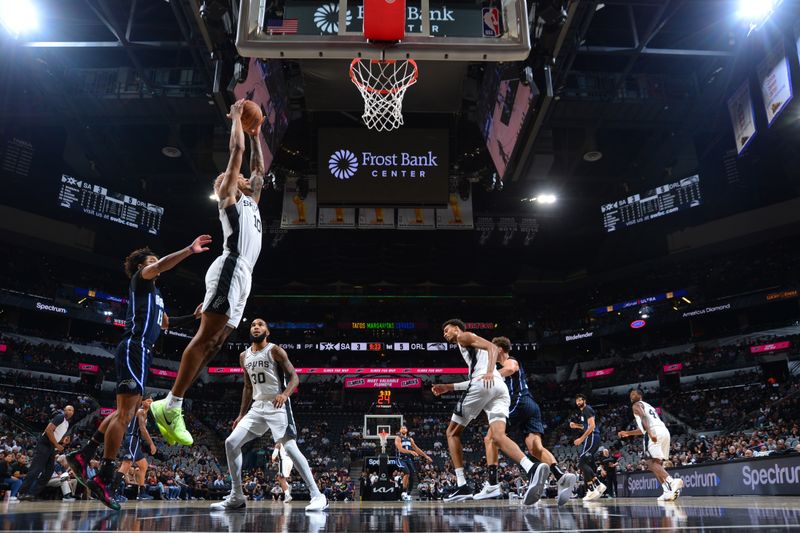 SAN ANTONIO, TX - OCTOBER 9: Jeremy Sochan #10 of the San Antonio Spurs rebounds the ball during the game against the Orlando Magic during a NBA preseason game on October 9, 2024 at the Frost Bank Center in San Antonio, Texas. NOTE TO USER: User expressly acknowledges and agrees that, by downloading and or using this photograph, user is consenting to the terms and conditions of the Getty Images License Agreement. Mandatory Copyright Notice: Copyright 2024 NBAE (Photos by Michael Gonzales/NBAE via Getty Images)