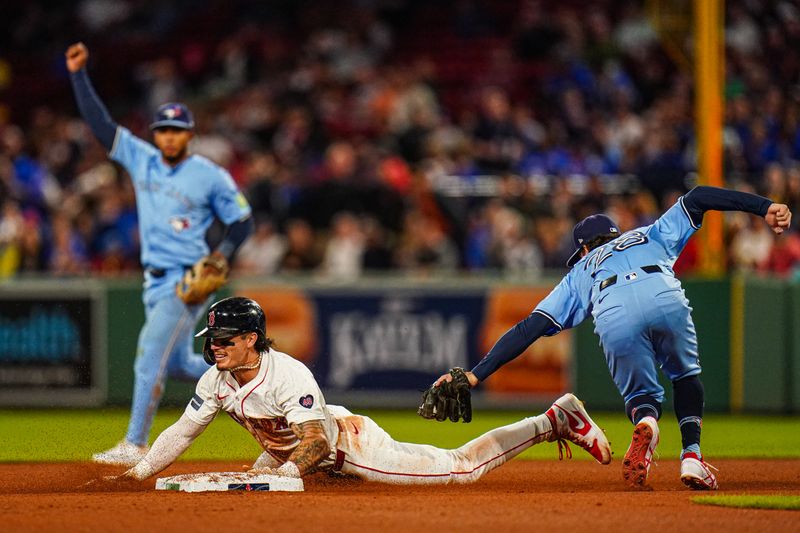 Aug 29, 2024; Boston, Massachusetts, USA; Boston Red Sox center fielder Jarren Duran (16) tagged out by Toronto Blue Jays shortstop Ernie Clement (28) in the fourth inning at Fenway Park. Mandatory Credit: David Butler II-USA TODAY Sports