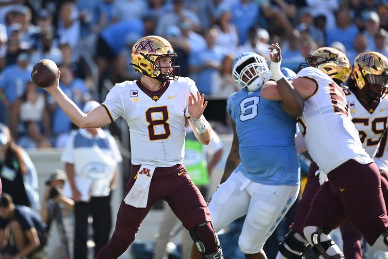 Sep 16, 2023; Chapel Hill, North Carolina, USA;  Minnesota Golden Gophers quarterback Athan Kaliakmanis (8) looks to pass as North Carolina Tar Heels defensive lineman Myles Murphy (8) pressures in the second quarter at Kenan Memorial Stadium. Mandatory Credit: Bob Donnan-USA TODAY Sports