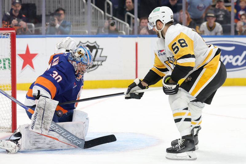 Nov 5, 2024; Elmont, New York, USA; New York Islanders goaltender Ilya Sorokin (30) makes the winning save against Pittsburgh Penguins defenseman Kris Letang (58) during the shootout at UBS Arena. Mandatory Credit: Brad Penner-Imagn Images