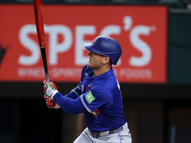 May 26, 2025; Arlington, Texas, USA; Toronto Blue Jays outfielder Daulton Varsho (5) hits a home run during the first inning against the Texas Rangers at Globe Life Field. Mandatory Credit: Tim Heitman-Imagn Images