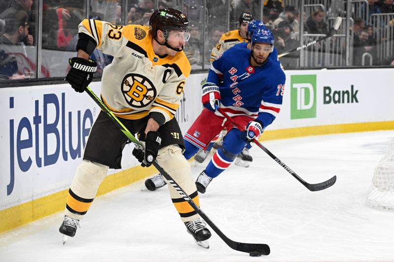 Mar 21, 2024; Boston, Massachusetts, USA; Boston Bruins left wing Brad Marchand (63) controls the puck against New York Rangers defenseman K'Andre Miller (79) during the first period at the TD Garden. Mandatory Credit: Brian Fluharty-USA TODAY Sports