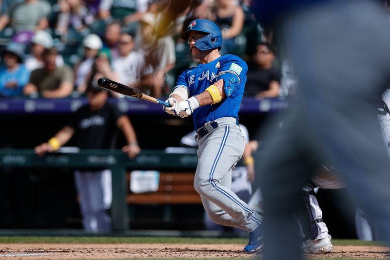 Sep 3, 2023; Denver, Colorado, USA; Toronto Blue Jays second baseman Davis Schneider (36) hits an RBI double in the fifth inning against the Colorado Rockies at Coors Field. Mandatory Credit: Isaiah J. Downing-USA TODAY Sports