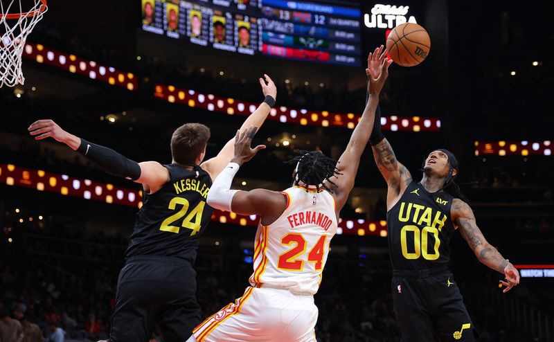 ATLANTA, GEORGIA - FEBRUARY 27:  Bruno Fernando #24 of the Atlanta Hawks battles for a rebound against Walker Kessler #24 and Jordan Clarkson #00 of the Utah Jazz during the first quarter at State Farm Arena on February 27, 2024 in Atlanta, Georgia.  NOTE TO USER: User expressly acknowledges and agrees that, by downloading and/or using this photograph, user is consenting to the terms and conditions of the Getty Images License Agreement.  (Photo by Kevin C. Cox/Getty Images)