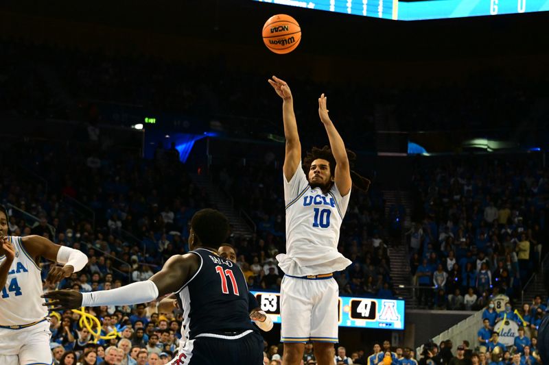 Mar 4, 2023; Los Angeles, California, USA; UCLA Bruins guard Tyger Campbell (10) shoots against Arizona Wildcats center Oumar Ballo (11) in the second half at Pauley Pavilion presented by Wescom. Mandatory Credit: Richard Mackson-USA TODAY Sports