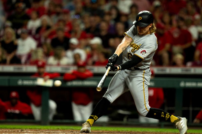 Sep 23, 2023; Cincinnati, Ohio, USA; Pittsburgh Pirates center fielder Jack Suwinski (65) hits an RBI base hit in the eighth inning against the Cincinnati Reds at Great American Ball Park. Mandatory Credit: The Cincinnati Enquirer-USA TODAY Sports