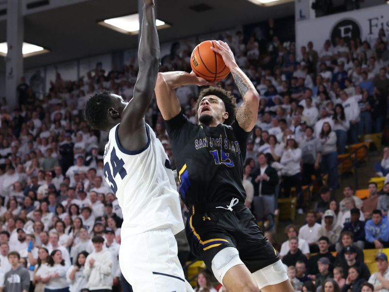 Jan 30, 2024; Logan, Utah, USA; San Jose State Spartans forward Trey Anderson (15) drives to the basket against Utah State Aggies forward Kalifa Sakho (34) during the first half at Dee Glen Smith Spectrum. Mandatory Credit: Rob Gray-USA TODAY Sports