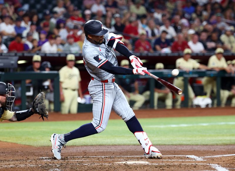 Jun 25, 2024; Phoenix, Arizona, USA; Minnesota Twins outfielder Byron Buxton bats against the Arizona Diamondbacks at Chase Field. Mandatory Credit: Mark J. Rebilas-USA TODAY Sports