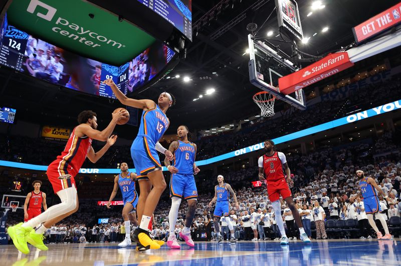 OKLAHOMA CITY, OKLAHOMA - APRIL 24:  Jeremiah Robinson-Earl #50 of the New Orleans Pelicans drives to the basket as Ousmane Dieng #13 of the Oklahoma City Thunder defends during game two of the first round of the NBA playoffs at Paycom Center on April 24, 2024 in Oklahoma City, Oklahoma. (Photo by Jamie Squire/Getty Images)