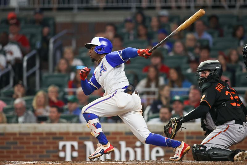 May 6, 2023; Atlanta, Georgia, USA; Atlanta Braves second baseman Ozzie Albies (1) hits a single against the Baltimore Orioles in the eighth inning at Truist Park. Mandatory Credit: Brett Davis-USA TODAY Sports
