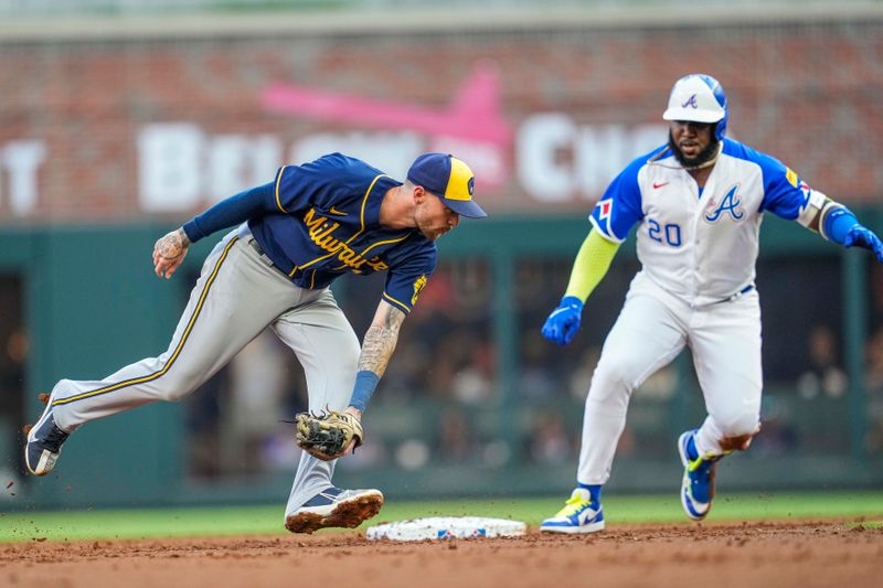 Jul 29, 2023; Cumberland, Georgia, USA; Milwaukee Brewers second baseman Brice Turang (0) takes a throw too late to tag Atlanta Braves designated hitter Marcell Ozuna (20) during the first inning at Truist Park. Mandatory Credit: Dale Zanine-USA TODAY Sports