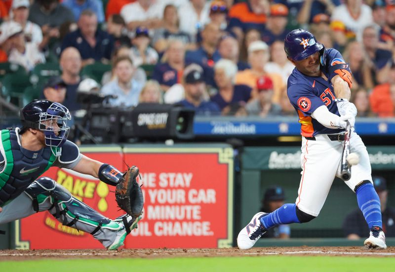 Jun 16, 2024; Houston, Texas, USA; Houston Astros second baseman Jose Altuve (27) hits a three run home run against the Detroit Tigers in the second inning at Minute Maid Park. Mandatory Credit: Thomas Shea-USA TODAY Sports