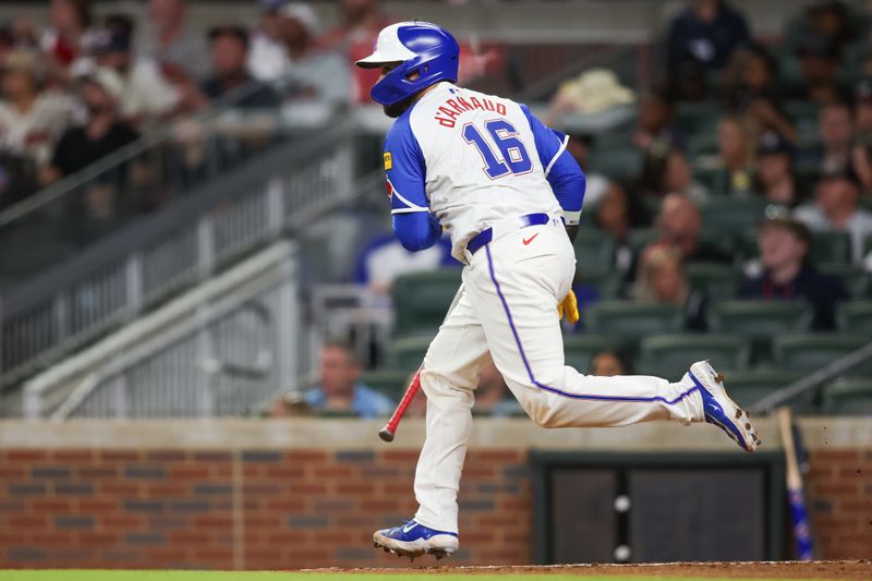 Aug 24, 2024; Atlanta, Georgia, USA; Atlanta Braves catcher Travis d'Arnaud (16) hits an RBI single against the Washington Nationals in the sixth inning at Truist Park. Mandatory Credit: Brett Davis-USA TODAY Sports
