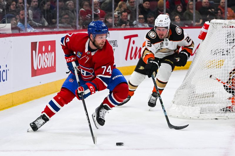 Feb 13, 2024; Montreal, Quebec, CAN; Montreal Canadiens center Brandon Gignac (74) plays the puck against Anaheim Ducks center Mason McTavish (23) during the second period at Bell Centre. Mandatory Credit: David Kirouac-USA TODAY Sports