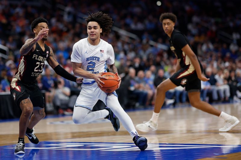 Mar 14, 2024; Washington, D.C., USA; North Carolina guard Elliot Cadeau (2) drives to the basket as Florida State guard Primo Spears (23) defends in the second half at Capital One Arena. Mandatory Credit: Geoff Burke-USA TODAY Sports