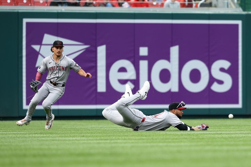Apr 6, 2025; Washington, District of Columbia, USA; Arizona Diamondbacks outfielder Lourdes Gurriel Jr. (12) cannot catch the ball during the sixth inning against the Washington Nationals at Nationals Park. Mandatory Credit: Daniel Kucin Jr.-Imagn Images