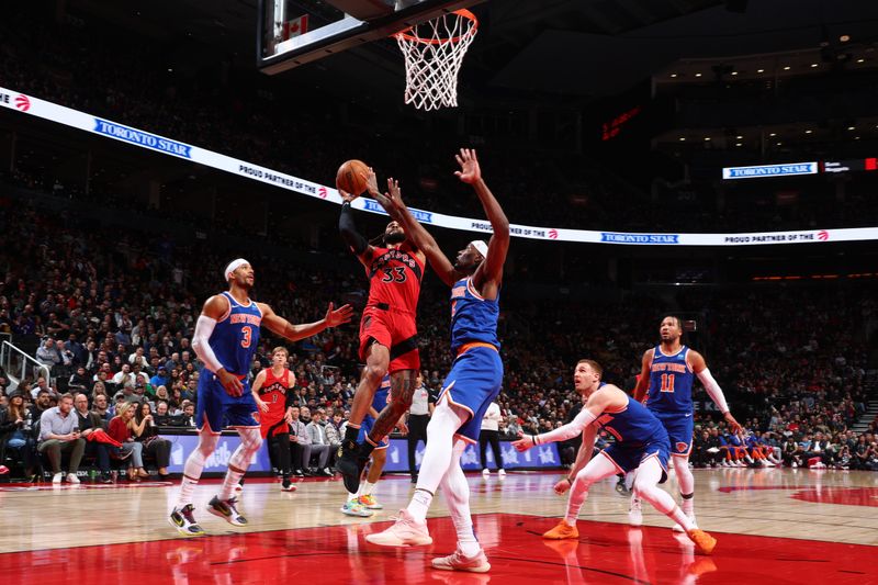 TORONTO, CANADA - MARCH 27: Gary Trent Jr. #33 of the Toronto Raptors drives to the basket during the game against the New York Knicks on March 27, 2024 at the Scotiabank Arena in Toronto, Ontario, Canada.  NOTE TO USER: User expressly acknowledges and agrees that, by downloading and or using this Photograph, user is consenting to the terms and conditions of the Getty Images License Agreement.  Mandatory Copyright Notice: Copyright 2024 NBAE (Photo by Vaughn Ridley/NBAE via Getty Images)