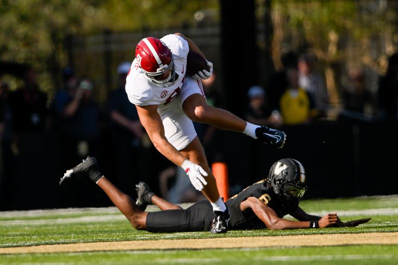 Oct 5, 2024; Nashville, Tennessee, USA;  Alabama Crimson Tide tight end CJ Dippre (81) breaks the tackle of Vanderbilt Commodores cornerback Tyson Russell (8) during the first half at FirstBank Stadium. Mandatory Credit: Steve Roberts-Imagn Images