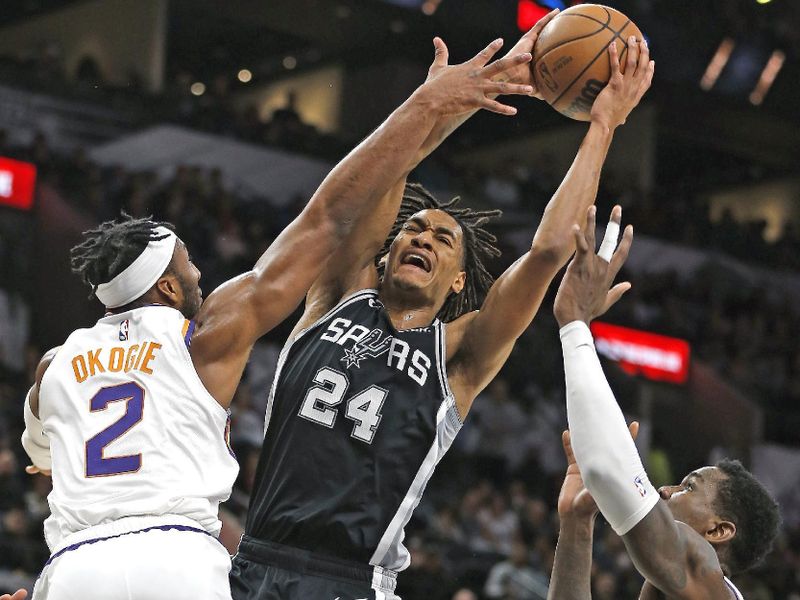 SAN ANTONIO, TX - DECEMBER 4: Devin Vassell #24 of the San Antonio Spurs is called for a foul on Josh Okogie #2 of the Phoenix Suns as he drives to the basket in the first half of the game at AT&T Center on December 4, 2022 in San Antonio, Texas. NOTE TO USER: User expressly acknowledges and agrees that, by downloading and or using this photograph, User is consenting to terms and conditions of the Getty Images License Agreement. (Photo by Ronald Cortes/Getty Images)