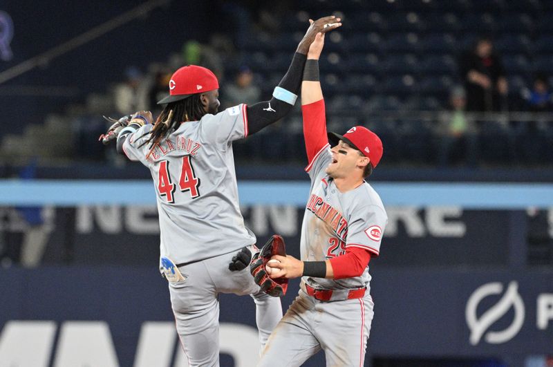 Aug 21, 2024; Toronto, Ontario, CAN;  Cincinnati Reds shortstop Elly De La Cruz (44) celebrates with center fielder TJ Friedl (29) after a win over the Toronto Blue Jays at Rogers Centre. Mandatory Credit: Dan Hamilton-USA TODAY Sports