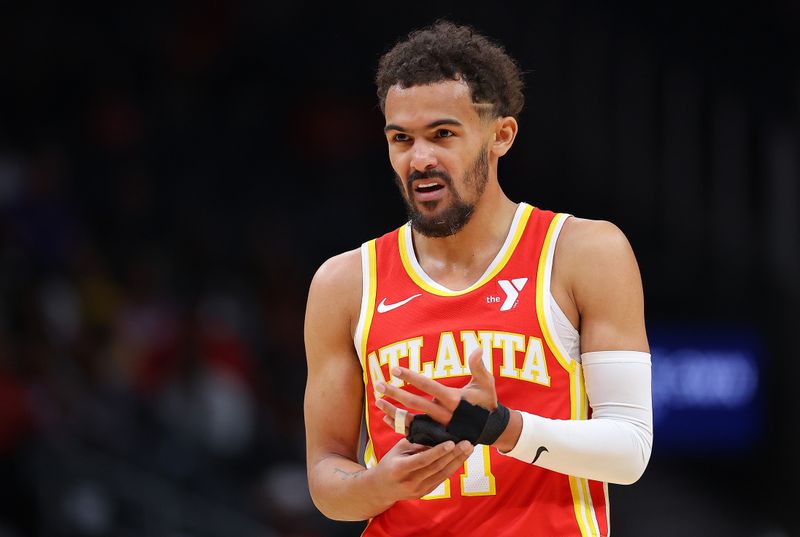 ATLANTA, GEORGIA - APRIL 10:  Trae Young #11 of the Atlanta Hawks grabs his wrapped finger after drawing a foul against the Charlotte Hornets during the first quarter at State Farm Arena on April 10, 2024 in Atlanta, Georgia.  NOTE TO USER: User expressly acknowledges and agrees that, by downloading and/or using this photograph, user is consenting to the terms and conditions of the Getty Images License Agreement.  (Photo by Kevin C. Cox/Getty Images)