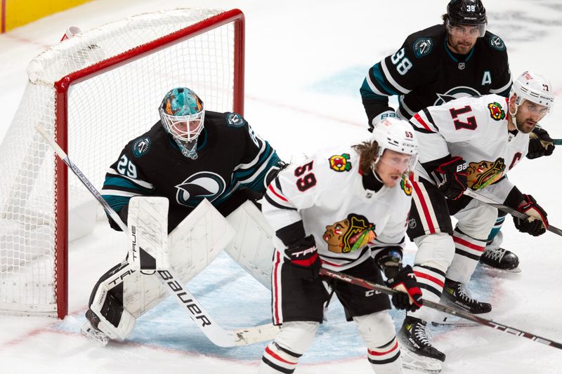 Oct 31, 2024; San Jose, California, USA; San Jose Sharks goaltender Mackenzie Blackwood (29) cranes his neck to look around Chicago Blackhawks left wingers Tyler Bertuzzi (59) and Nick Foligno (17) during the third period at SAP Center at San Jose. Mandatory Credit: D. Ross Cameron-Imagn Images