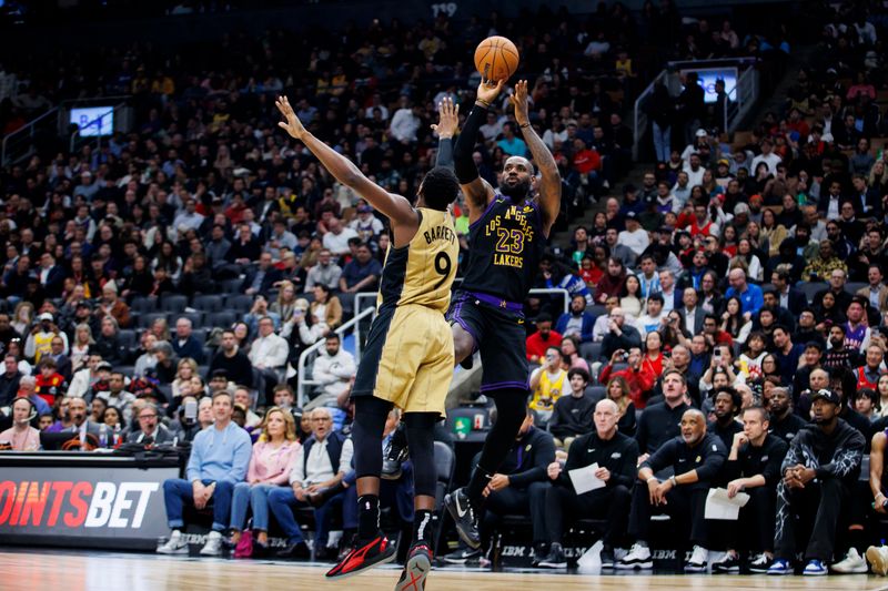 TORONTO, CANADA - APRIL 2: LeBron James #23 of the Los Angeles Lakers puts up a shot over RJ Barrett #9 of the Toronto Raptors in the first half at Scotiabank Arena on April 2, 2024 in Toronto, Canada. NOTE TO USER: User expressly acknowledges and agrees that, by downloading and or using this photograph, User is consenting to the terms and conditions of the Getty Images License Agreement. (Photo by Cole Burston/Getty Images)