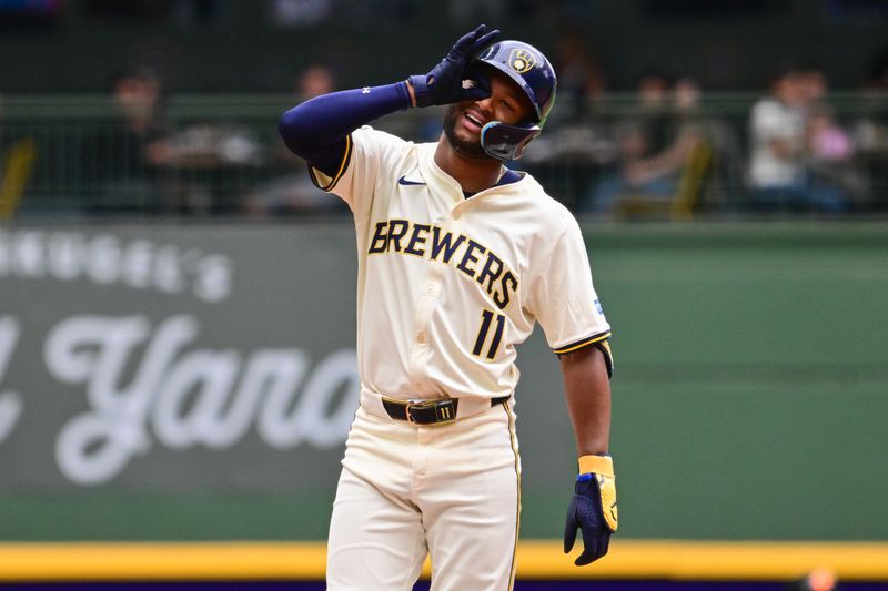 Aug 29, 2024; Milwaukee, Wisconsin, USA;  Milwaukee Brewers left fielder Jackson Chourio (11) reacts after hitting a double to drive in two runs in the fourth inning against the San Francisco Giants at American Family Field. Mandatory Credit: Benny Sieu-USA TODAY Sports