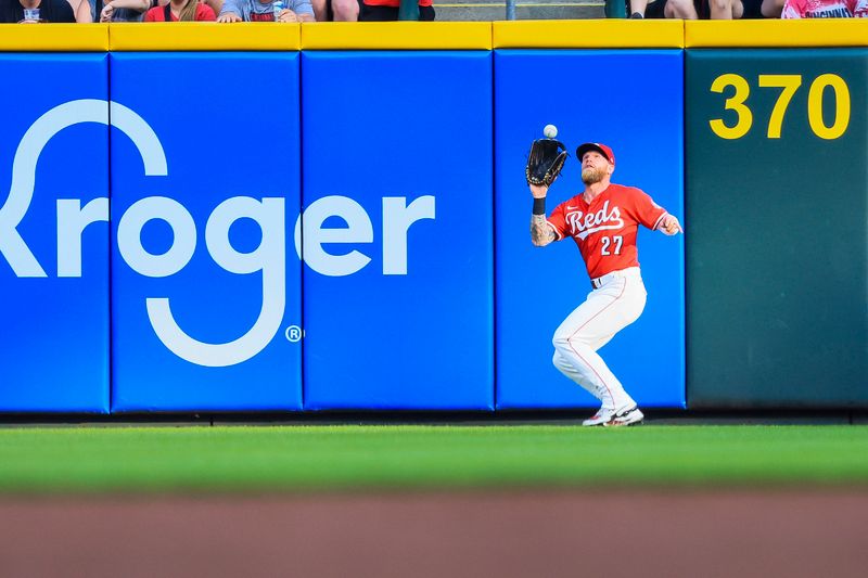 Jun 3, 2025; Cincinnati, Ohio, USA; Cincinnati Reds outfielder Jake Fraley (27) catches a fly out hit by Milwaukee Brewers outfielder Isaac Collins (not pictured) in the second inning at Great American Ball Park. Mandatory Credit: Katie Stratman-Imagn Images
