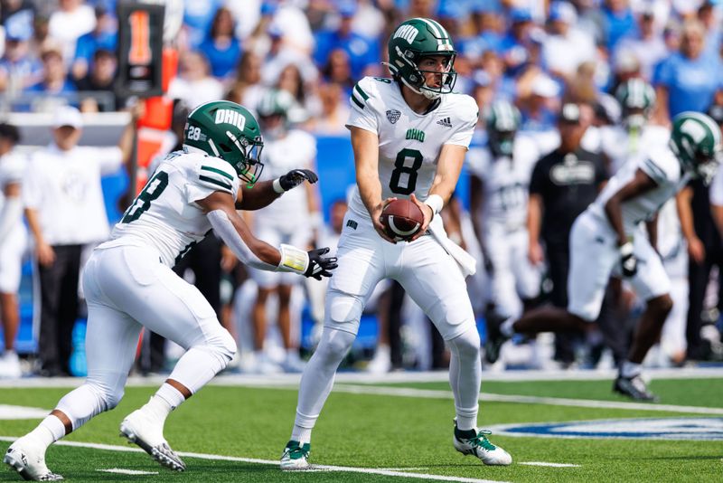 Sep 21, 2024; Lexington, Kentucky, USA; Ohio Bobcats quarterback Nick Poulos (8) hand the ball off to running back Rickey Hunt Jr. (28) during the first quarter against the Kentucky Wildcats at Kroger Field. Mandatory Credit: Jordan Prather-Imagn Images