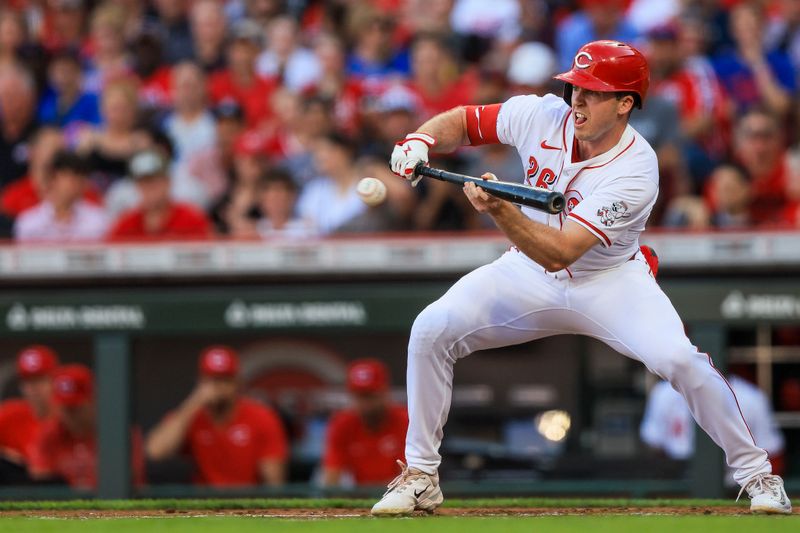 Jun 6, 2024; Cincinnati, Ohio, USA; Cincinnati Reds outfielder Jacob Hurtubise (26) attempts to bunt against the Chicago Cubs in the second inning at Great American Ball Park. Mandatory Credit: Katie Stratman-USA TODAY Sports