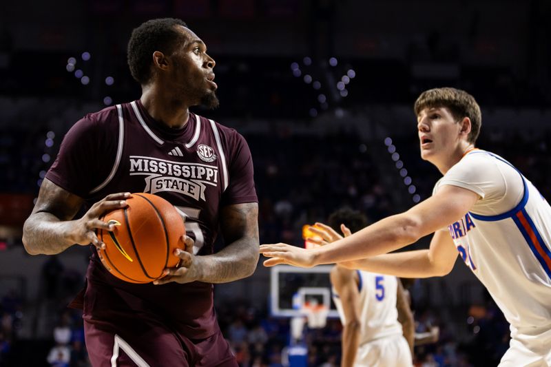 Jan 24, 2024; Gainesville, Florida, USA; Mississippi State Bulldogs forward Jimmy Bell Jr. (15) looks to pass away from Florida Gators forward Alex Condon (21) during the first half at Exactech Arena at the Stephen C. O'Connell Center. Mandatory Credit: Matt Pendleton-USA TODAY Sports