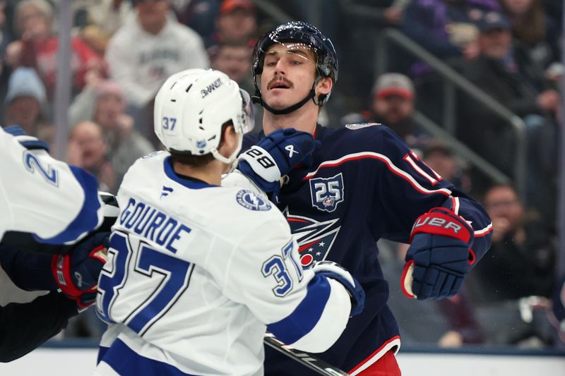 Jan 24, 2026; Columbus, Ohio, USA; Tampa Bay Lightning center Yanni Gourde (37) and Columbus Blue Jackets left wing Mason Marchment (17) fight during the second period at Nationwide Arena. Mandatory Credit: Joseph Maiorana-Imagn Images