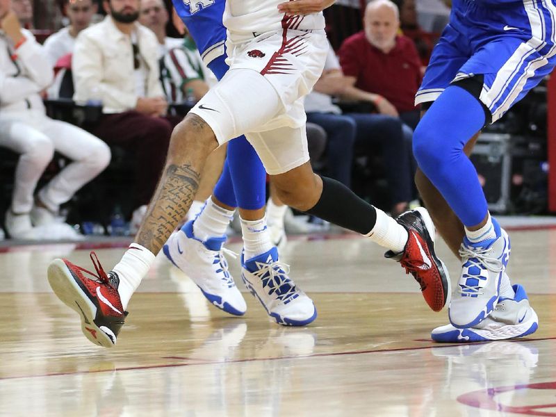 Mar 4, 2023; Fayetteville, Arkansas, USA; Arkansas Razorbacks guard Nick Smith Jr (3) drives between Kentucky Wildcats forward Jacob Toppin (0) and guard Antonio Reeves (12) during the second half at Bud Walton Arena. Kentucky won 88-79. Mandatory Credit: Nelson Chenault-USA TODAY Sports