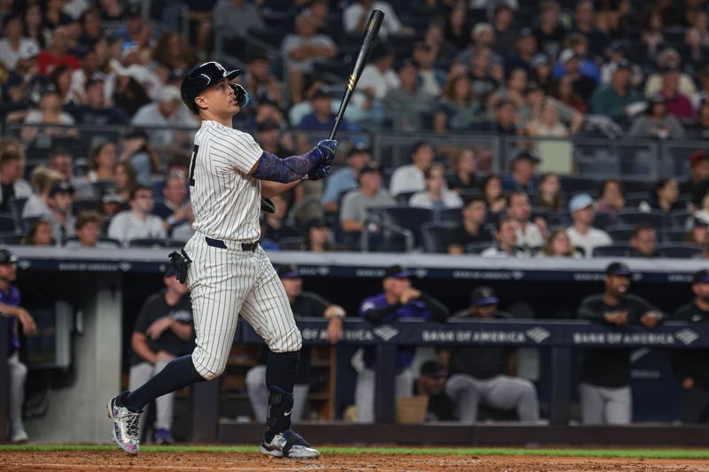 Aug 23, 2024; Bronx, New York, USA;  New York Yankees designated hitter Giancarlo Stanton (27) hits a solo home run during the fourth inning against the Colorado Rockies at Yankee Stadium. Mandatory Credit: Vincent Carchietta-USA TODAY Sports