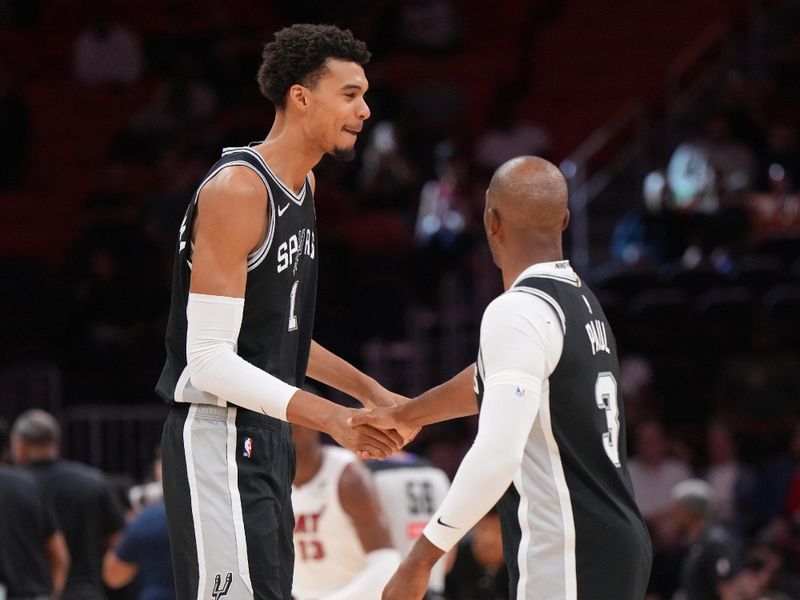 MIAMI, FL - OCTOBER 15: Victor Wembanyama #1 and Chris Paul #3 of the San Antonio Spurs talk during the game against the Miami Heat during a NBA preseason game on October 15, 2024 at Kaseya Center in Miami, Florida. NOTE TO USER: User expressly acknowledges and agrees that, by downloading and or using this Photograph, user is consenting to the terms and conditions of the Getty Images License Agreement. Mandatory Copyright Notice: Copyright 2024 NBAE (Photo by Jesse D. Garrabrant/NBAE via Getty Images)