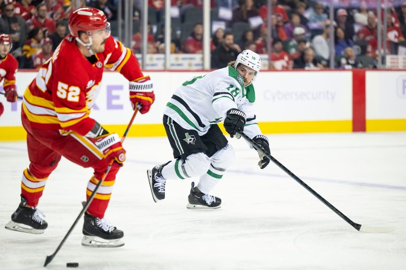 Nov 22, 2025; Calgary, Alberta, CAN; Dallas Stars center Sam Steel (18) tries to intercept a pass from Calgary Flames defenseman Mackenzie Weegar (52) during the first period at Scotiabank Saddledome. Mandatory Credit: Brett Holmes-Imagn Images