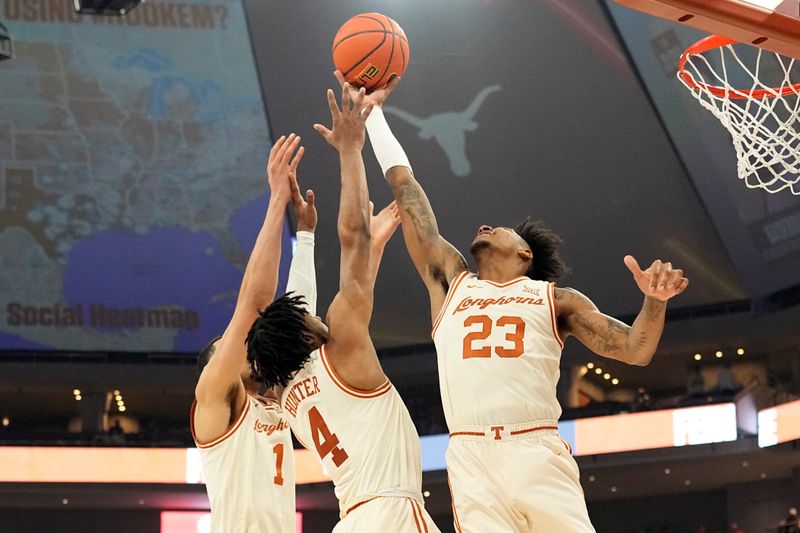 Feb 19, 2024; Austin, Texas, USA; Texas Longhorns forward Dillon Mitchell (23) and guard Tyrese Hunter (4) reach for a rebound during the second half against the Kansas State Wildcats at Moody Center. Mandatory Credit: Scott Wachter-USA TODAY Sports