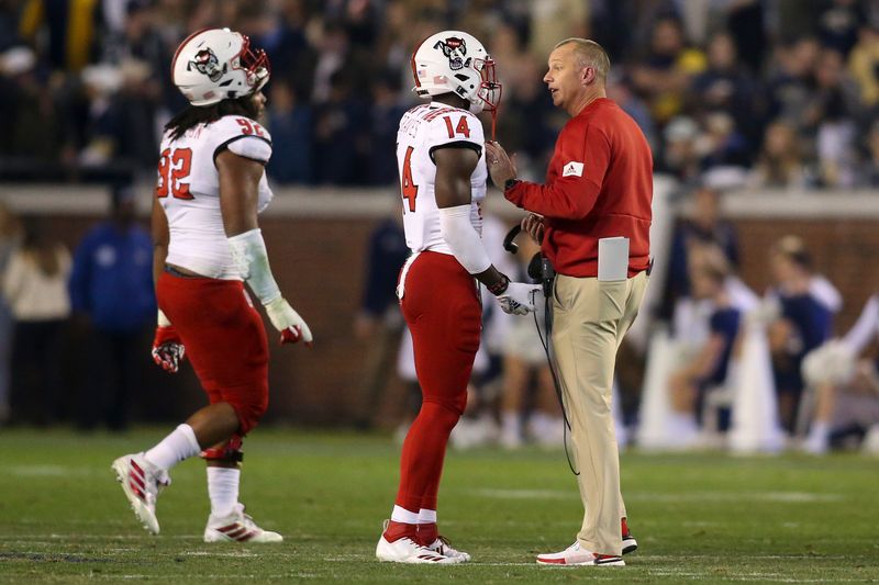 Nov 21, 2019; Atlanta, GA, USA; North Carolina State Wolfpack head coach Dave Doeren talks to safety De'Von Graves (14) against the Georgia Tech Yellow Jackets in the first half at Bobby Dodd Stadium. Mandatory Credit: Brett Davis-USA TODAY Sports