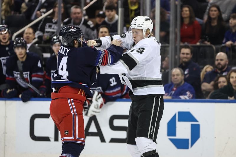 Dec 14, 2024; New York, New York, USA;  New York Rangers defenseman Connor Mackey (14) and Los Angeles Kings center Samuel Helenius in the first period at Madison Square Garden. Mandatory Credit: Wendell Cruz-Imagn Images