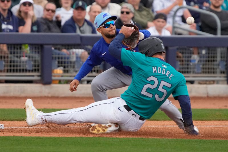 Mar 24, 2024; Peoria, Arizona, USA; Seattle Mariners left fielder Dylan Moore (25) slides onto third-base safe under the tag by Chicago Cubs third baseman Nick Madrigal (1) in the second inning at Peoria Sports Complex. Mandatory Credit: Rick Scuteri-USA TODAY Sports