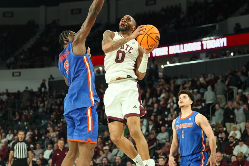 Feb 11, 2025; Starkville, Mississippi, USA; Mississippi State Bulldogs guard Claudell Harris Jr. (0) shoots as Florida Gators center Rueben Chinyelu (9) defends during the second half at Humphrey Coliseum. Mandatory Credit: Wesley Hale-Imagn Images