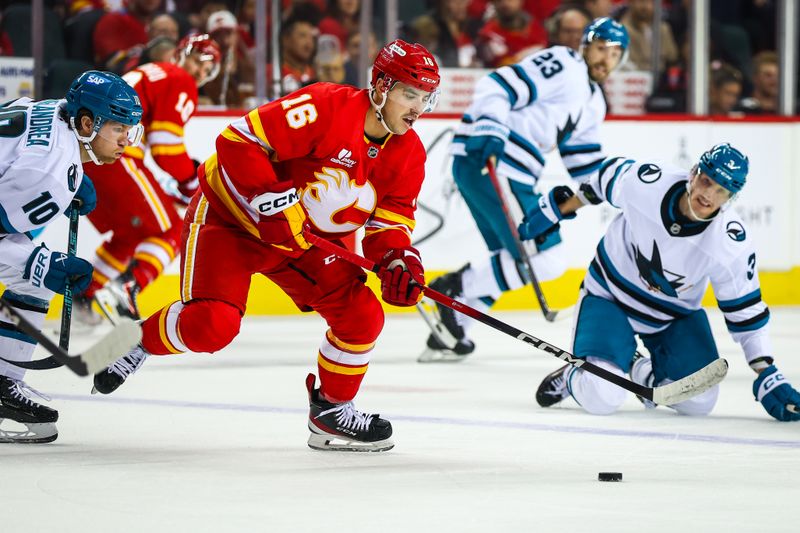 Nov 13, 2025; Calgary, Alberta, CAN; Calgary Flames center Morgan Frost (16) controls the puck against the San Jose Sharks during the first period at Scotiabank Saddledome. Mandatory Credit: Sergei Belski-Imagn Images