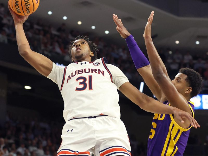 Jan 13, 2024; Auburn, Alabama, USA; Auburn Tigers guard Chaney Johnson (31) takes a shot as LSU Tigers guard Jordan Wright (6) defends during the second half at Neville Arena. Mandatory Credit: John Reed-USA TODAY Sports