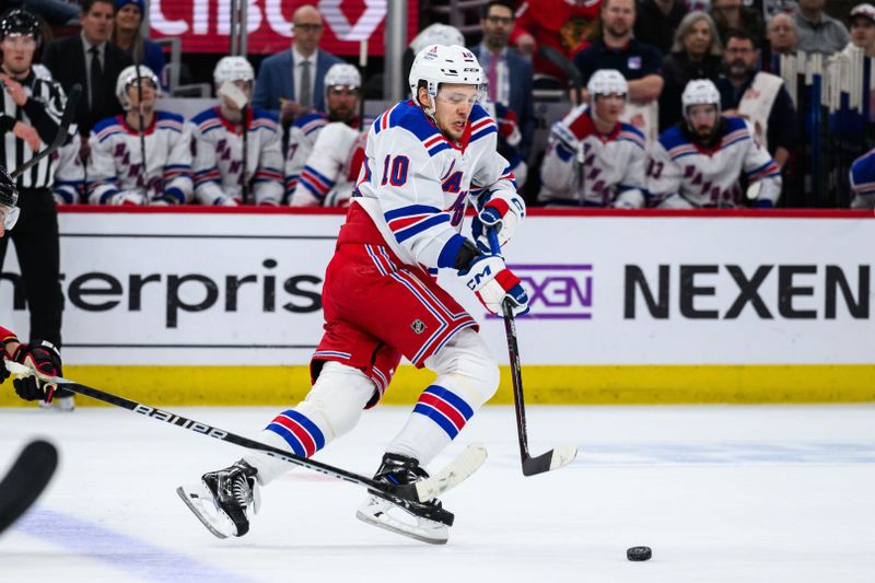 Feb 9, 2024; Chicago, Illinois, USA; New York Rangers left wing Artemi Panarin (10) skates with the puck against the Chicago Blackhawks during the first period at the United Center. Mandatory Credit: Daniel Bartel-USA TODAY Sports