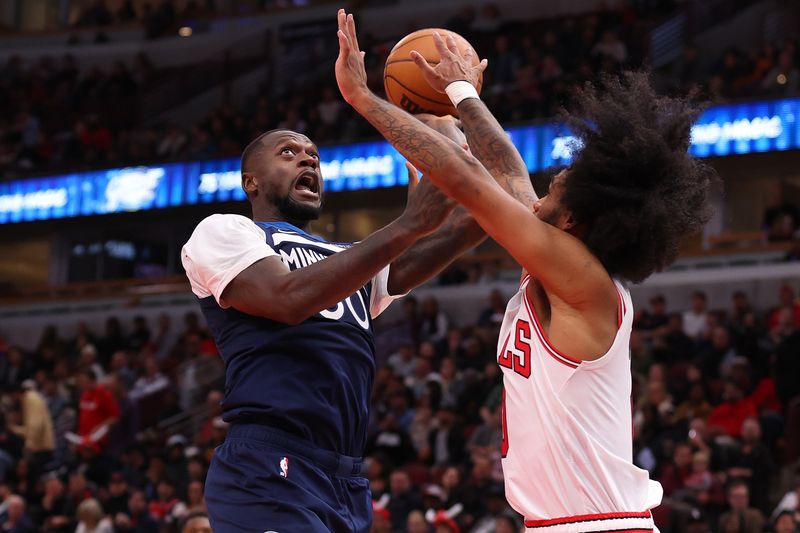 CHICAGO, ILLINOIS - OCTOBER 16: Julius Randle #30 of the Minnesota Timberwolves shoots over Coby White #0 of the Chicago Bulls during the second half of a preseason game at the United Center on October 16, 2024 in Chicago, Illinois. NOTE TO USER: User expressly acknowledges and agrees that, by downloading and or using this photograph, User is consenting to the terms and conditions of the Getty Images License Agreement.  (Photo by Michael Reaves/Getty Images)